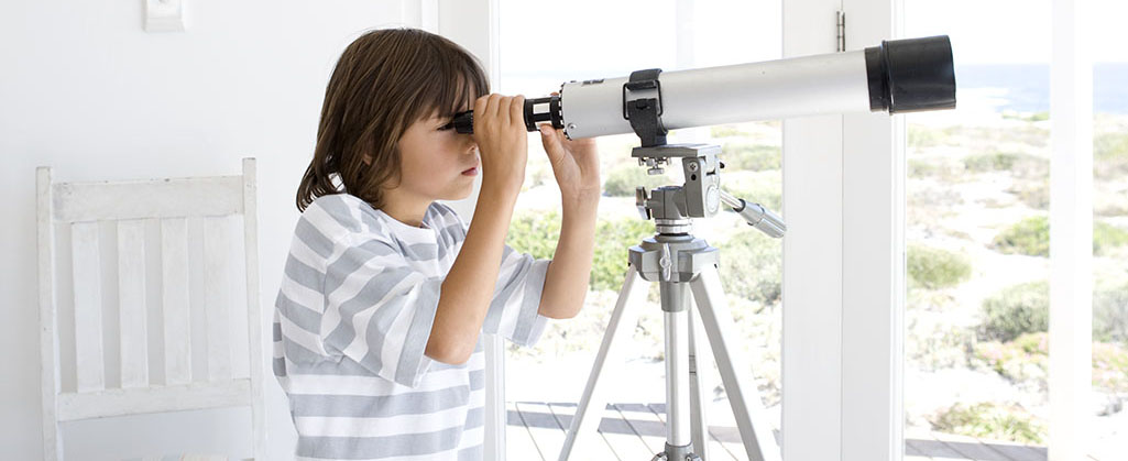 Boy looking through telescope