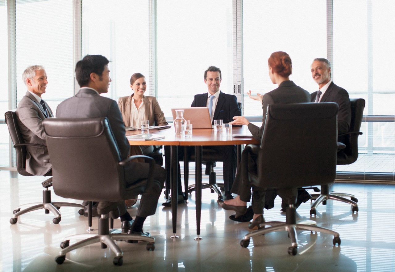 Businesspeople meeting at table in conference room, office, group