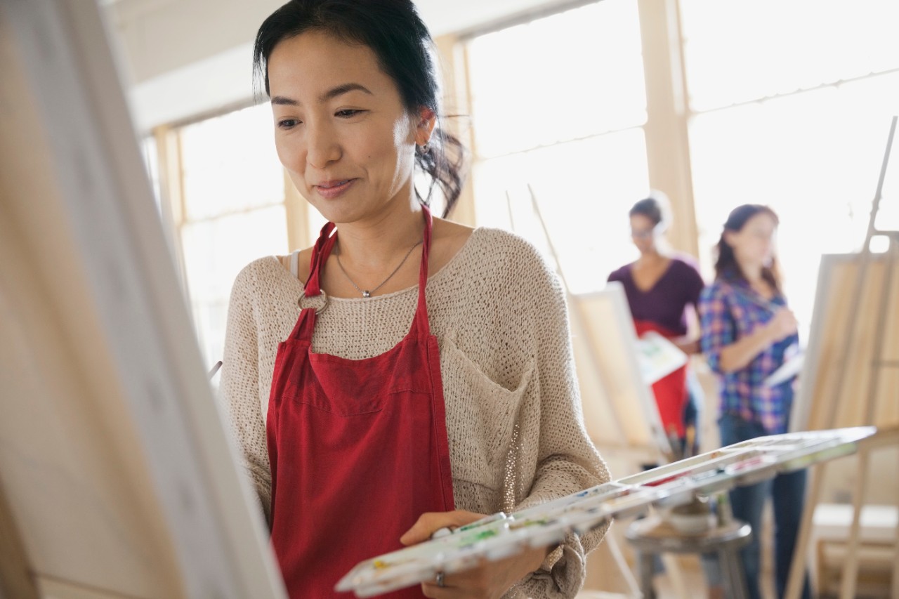 Woman painting in art class